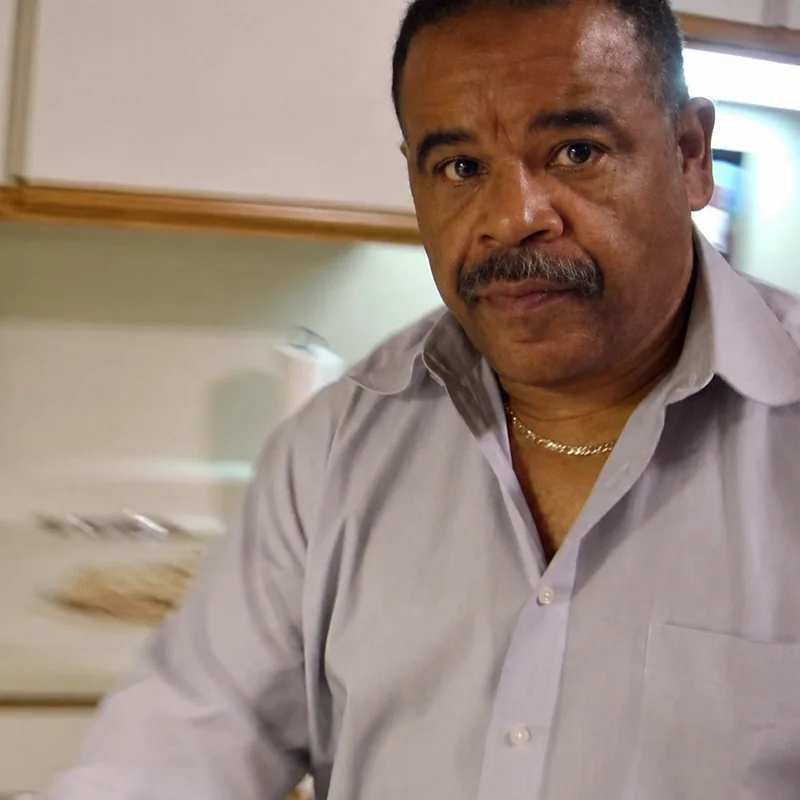 Johnathan Price, in a light lavender shirt
