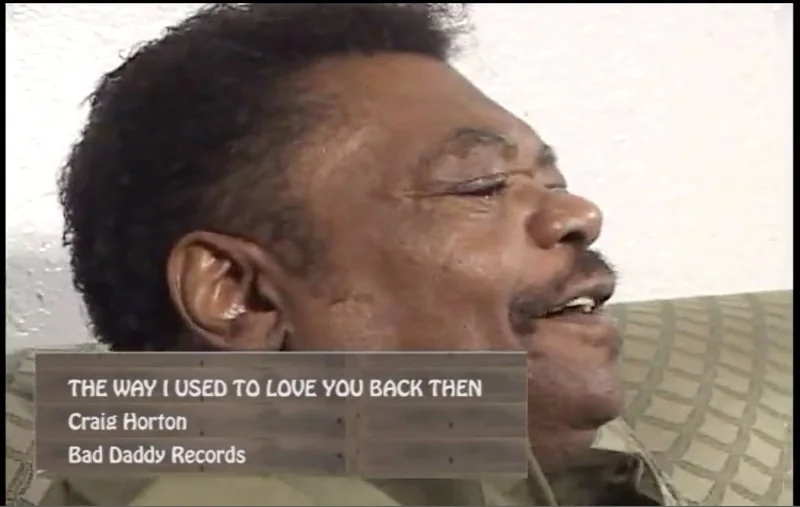 Craig Horton singing in a frame from a finished music video, with an on-screen caption reading “The Way I Used To Love You Back Then”